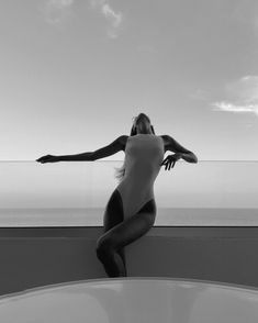 a black and white photo of a woman in a bathing suit