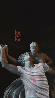 there is a statue in the dark with a red sign above it that says mia san mia