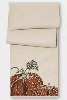 two orange pumpkins on a white sheet set