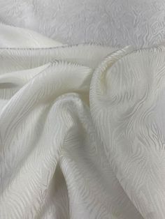 an up close shot of white fabric with wavy lines on the top and bottom of it