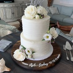 a white wedding cake with flowers on top