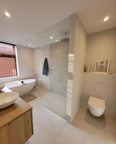 a bathroom with a large tub, sink and toilet next to a walk in shower