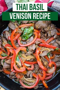 beef stir fry with peppers and onions in a skillet on top of a wooden table