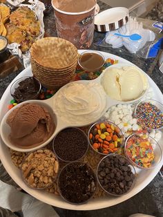 a white plate topped with lots of different types of desserts on top of a table