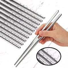 the 5 pairs of stainless steel straws are being held by a person's hand