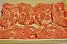 raw meat in a box with seasoning on top, ready to be cut into pieces