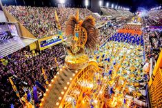 a large group of people standing in front of a crowd at a convention or festival