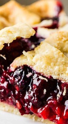 a close up of a berry pie on a plate