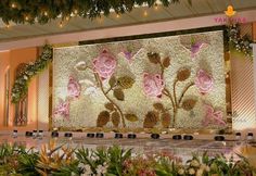 the floral wall is decorated with flowers and greenery for a special occasion or celebration