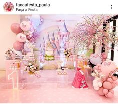 a pink princess themed birthday party with balloons and decorations on the walls, including castle