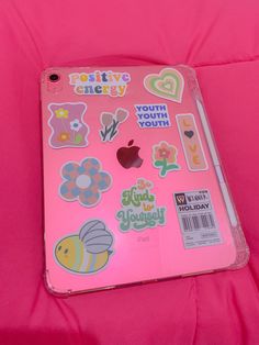 a pink ipad case with stickers on it