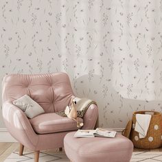 a pink chair and ottoman in front of a floral wallpaper