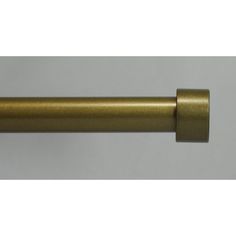 an antique brass curtain rod on a white background