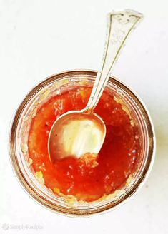 a spoon in a jar filled with sauce