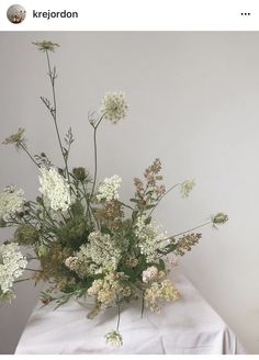 a bunch of flowers sitting on top of a white tablecloth covered table with text overlay that reads, krejodorn