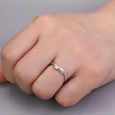 a person's hand with a ring on it