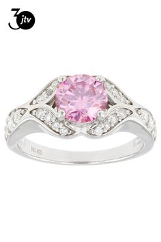 a pink diamond and white gold ring with diamonds on the band, set in 18k white