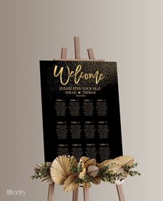 a black and gold wedding welcome sign on an easel