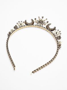 a tiara with stars and crescents on the headband is seen in this image