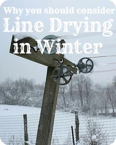 a wooden post in the snow with an old fashioned wheel on it's end