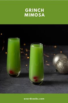 three glasses filled with green liquid next to christmas ornaments