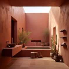 a bathroom with pink walls and tiled flooring, potted plants in the corner