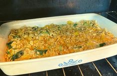 a casserole dish in an oven with broccoli and other food items