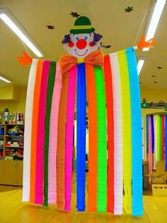 a large rainbow colored streamer with a clown face on it