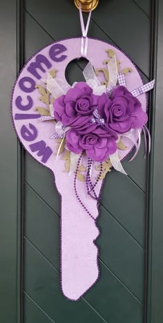 a door hanger decorated with purple flowers and the words welcome to me on it