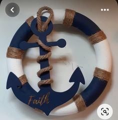 a blue and white life preserver with an anchor on it's side that says faith