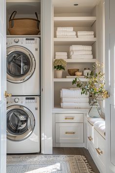 a washer and dryer in a closet with towels stacked on the shelves next to each other