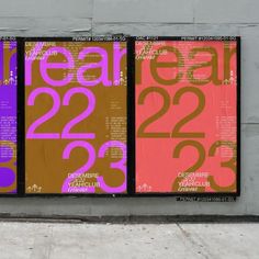 three large posters on the side of a building with numbers painted on them and words written in different colors