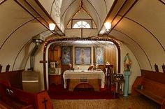 the inside of a church with pews and stained glass windows is shown in this image