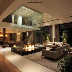 a living room filled with furniture and a fire place next to a large glass wall