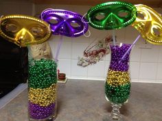 two vases with mardi gras decorations in them