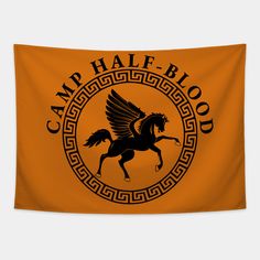 an orange wall hanging with a black horse and the words camp half blood on it