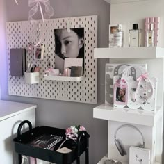 a room with shelves and pictures on the wall