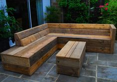 a wooden bench sitting on top of a stone patio