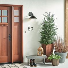 a pair of boots are sitting on a bench in front of a door with the number 50 written on it