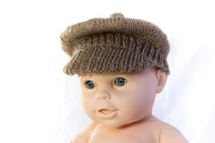 a baby doll wearing a knitted hat on top of it's head and body