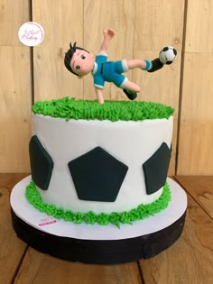 a birthday cake with a soccer player on top