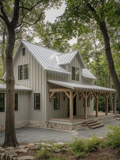 a large white house surrounded by trees and rocks