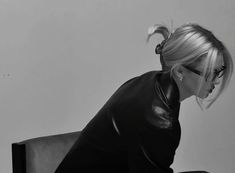 black and white photograph of a woman sitting on a chair