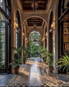 an ornate entry way with potted plants on either side and large windows above it