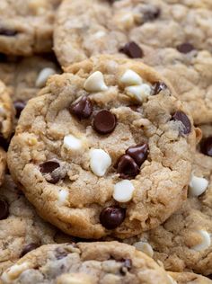 chocolate chip cookies with marshmallows are piled on top of eachother