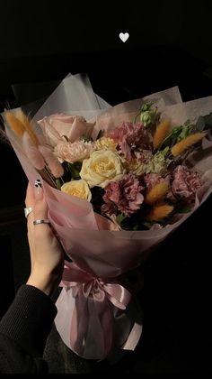 a person holding a bouquet of flowers in their hands