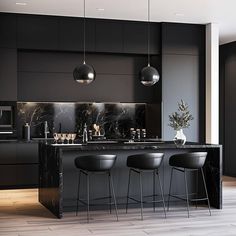 a black kitchen with marble counter tops and bar stools