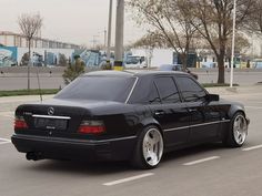 a black car is parked in the parking lot