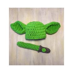 a crocheted green hat with an ear flap and ears attached to the top