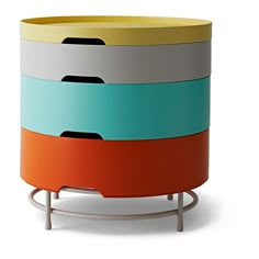 a multicolored round side table with metal legs and four sections on each side